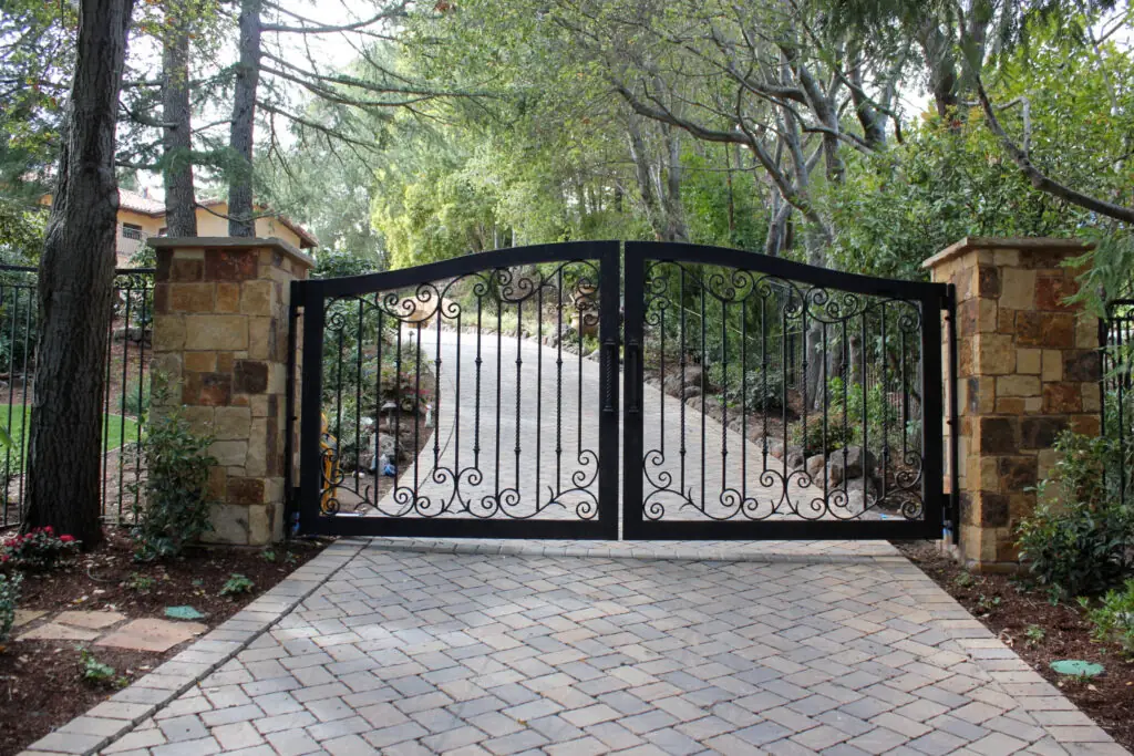 Powder-coated metal driveway gates fitted by Acorn Fencing